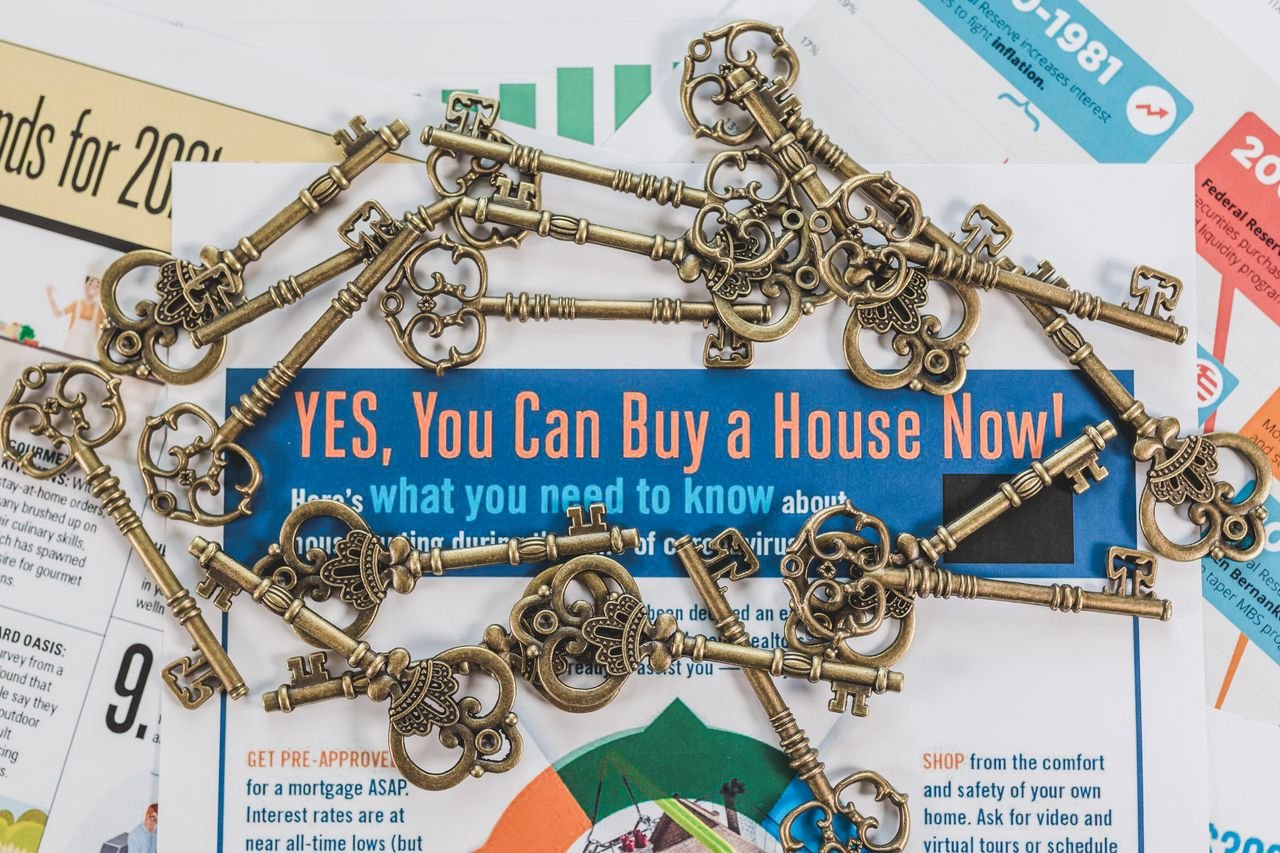 Home Vintage keys spread over real estate documents symbolizing property ownership and investment.